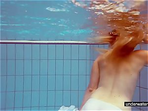 lovely redhead plays naked underwater